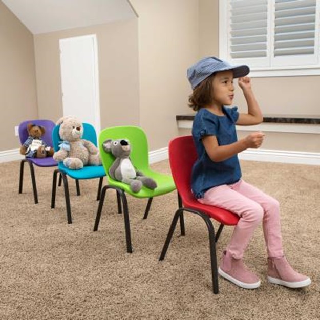 Girl sitting in a chair with stuffed animals